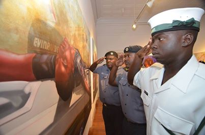 Royal Bahamas Defence Force Officers salute one of my paintings from the 'Swan Song of the Flamingo' exhibition, paying homage to the marines that were involved in the 'Flamingo Incident'.  Copyright Kishan Munroe.