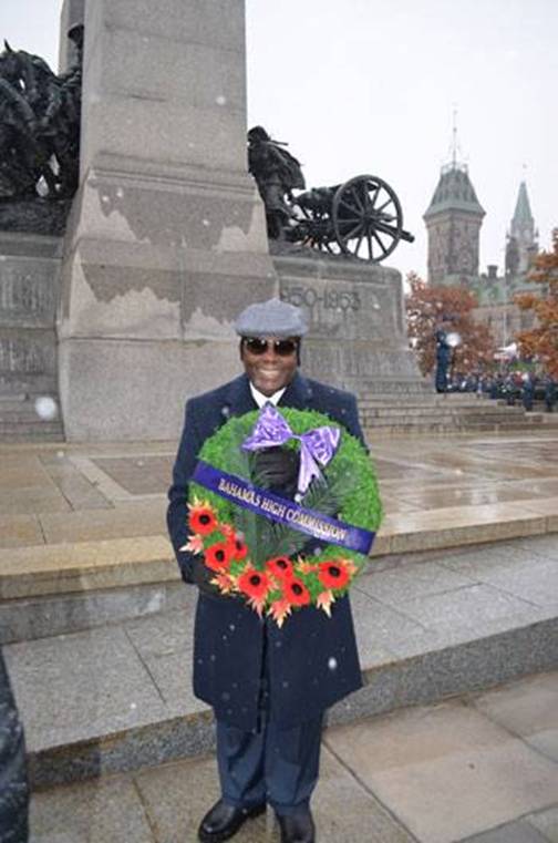 Photo: Government High Commissioners on a Mission.   His Excellency Dr. Calsey Johnson, High Commissioner for the Commonwealth of The Bahamas attended Canada’s Remembrance Day Ceremony on 11th November, 2013, when he laid a wreath to commemorate those lost in battle in the First and Second World Wars.  15,600 men of the British West Indies Regiment served with the Allied forces. Jamaica contributed two-thirds of these volunteers, while others came from Trinidad and Tobago, Barbados, The Bahamas, British Honduras, Grenada, British Guiana (now Guyana), the Leeward Islands, St Lucia and St Vincent. Nearly 5,000 more subsequently volunteered to join up. Out of a population of 1,700,000 in the Caribbean Colonies of the British Empire, over 1,200 were killed or died, while more than 2,500 were wounded.It was King George V of Britain who was the first to institute Remembrance Day, when on the 7th November, 1919, he set aside a day during the month of November as a day to remember British soldiers killed during World War I. The day chosen was specifically selected to coincide with the official end of World War I, “at the 11th hour (11:00 a.m.) of the 11th month 1918”. In like fashion, the Bahamian Government made the decision to commemorate Remembrance Day on the nearest Sunday to the November 7th by designating the 2nd Sunday in November as Remembrance Day.  On Remembrance Day, there are two services held, the first, an ecumenical service at Christ Church Cathedral, followed by a parade and a second service at the Garden of Remembrance. In attendance at the services are the Governor General, the Prime Minister of The Bahamas, Judiciary, other government dignitaries, heads of the Police and Defence Force Veterans from the Bahamian Chapter of the British Legion and their families.  Participating in the parade are Marching Youth Bands and Youth Organisations, including the Boy Scouts, Guides, Boys Brigade, Church Youth Groups, Cadet Sections of the Police and Defence Forces and government uniform branches. Veterans who are now all above the age of seventy and are no longer required to march in the parade. At the Garden of Remembrance a brief interdenominational service is held led by the Bahamian Christian Council followed by the laying of wreaths by the Diplomatic Corp and other Non Government Organisations (NGO) at the base of the Cenotaph.  By an Act of Parliament, the Royal Bahamas Defence Force became an official entity on 31 March 1980.The only combat action the RBDF has ever been involved with has been against Cuba. On 10 May 1980, the HMBS Flamingo attempted to arrest two Cuban fishing vessels, the Ferrocem 165 and the Ferrocem 54, for poaching in Bahamian waters. In retaliation, two Cuban MiG-21s invaded Bahamas airspace and fired on the patrol boat. The Cubans sank the ship with their 23mm cannons, and fired upon Marines in distress in the water Fenrick Sturrup, Austin Smith, David Tucker and Edward Williams, all Bahamian Defence Force Marines, were killed in the attack Fifteen crewmen and the Commander made it safely to Duncan Town, on Ragged Island, after being picked up by the fishing vessels they had boarded. The poachers were convicted in July 1980, and Cuba eventually admitted responsibility, paying the Bahamas $10 million in compensation for the incident.  .High Commissioner Johnson said that in laying the wreath, these four young men were very much in his thoughts along with the veterans from the two World Wars.